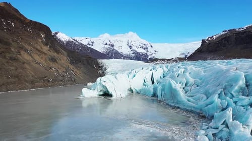 Aerial view of a blue glacier in Iceland. Cold Blue Ice, Frozen. Water Arctic winter landscape.