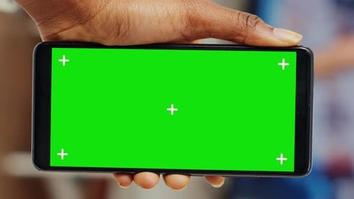 Hand Holding Smartphone with Green Screen for Compositing