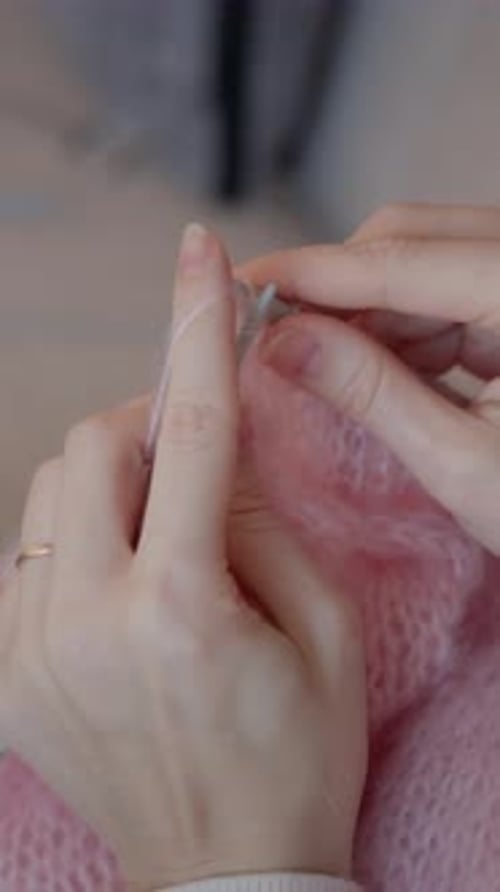 Vertical Close Up of Knitting Pink Wool by Hand