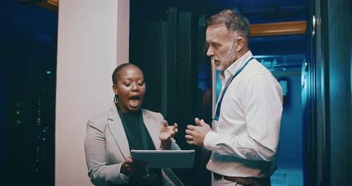 Data Center: Two Colleagues Discuss Information on Tablet
