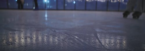 The Ice Rink at Night Shines with Beautiful Reflections and Joyful Skaters Enjoying It