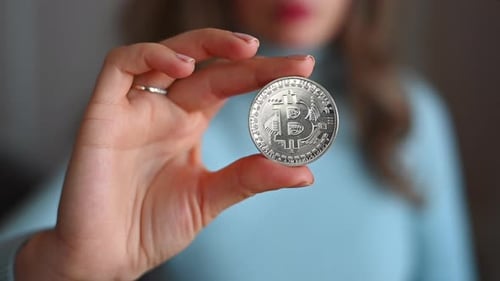Woman holding a bitcoin crypto currency close up