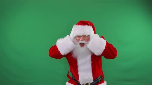 Santa raises his hands emotionally, shouts, calls for a sale with discounts, on a green background