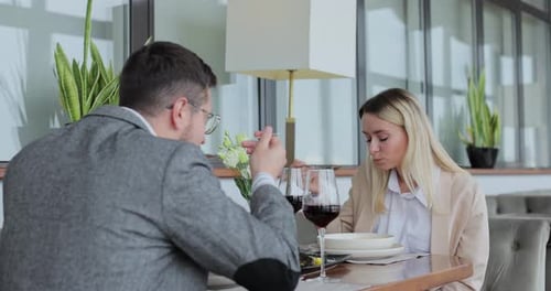 Couple Having a Dinner at a Restaurant People Enjoying Their Date Drinking Wine Eating and Chatting