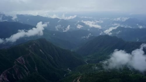 A Serene and Stunning Mountain Landscape Featuring Fog and Clouds Above the Horizon Stock Clip