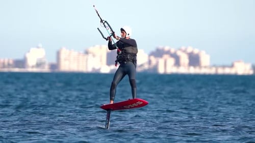 Sporstman practicce hydro foil kite surf boarding in Spain coast