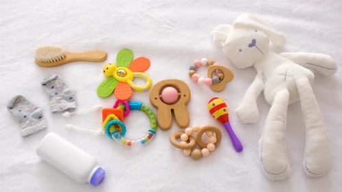 Baby Toys and Accessories on the Bed Selective Focus
