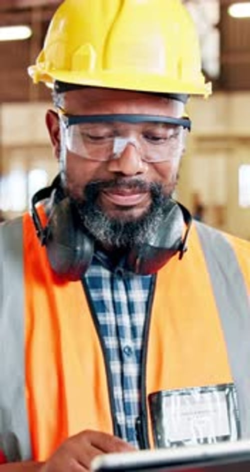 Black man, face and carpenter with tablet for building, construction or wood repair in workshop