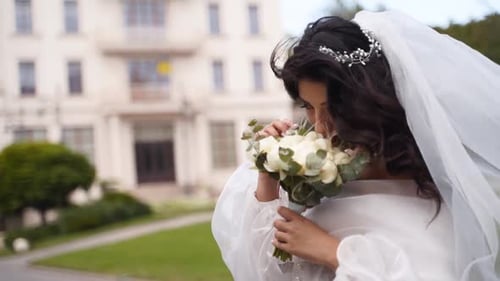 Elegant Bride Smells Her Wedding Bouquet