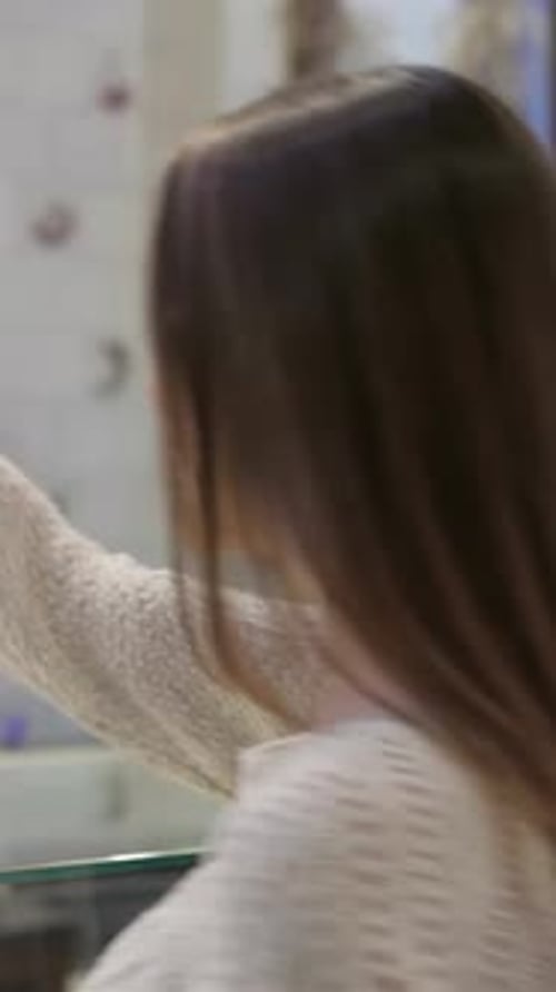 Charming Woman Savoring Freshly Baked Pastries in a Cozy Coffee Shop
