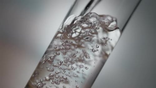 Water Being Poured Into Glass With Bubbles