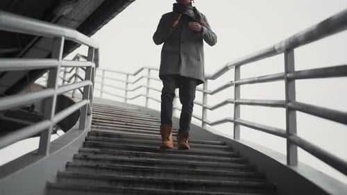 Walk in City in Cold Autumn or Winter Day Black Man Moving Down on Stairs Portrait of Young African