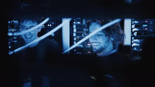 Two men analysing servers in a data center