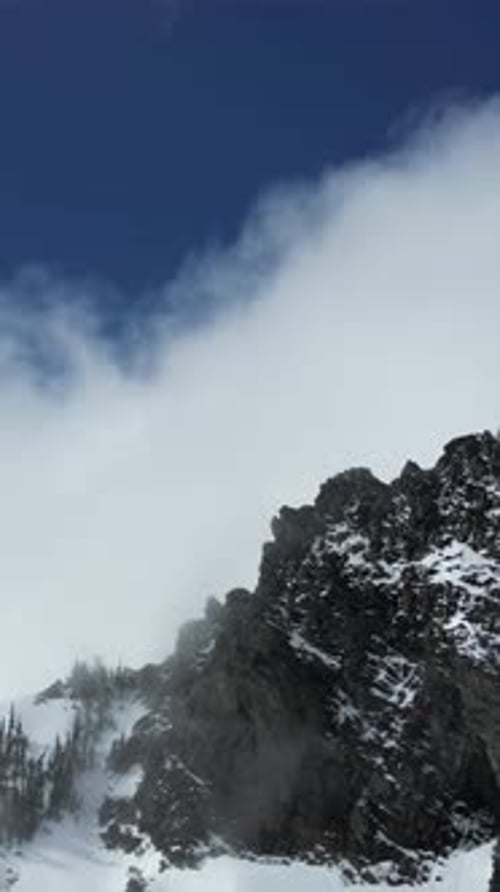 Snowy Mountain Peak And Clouds. British Columbia, Canada.