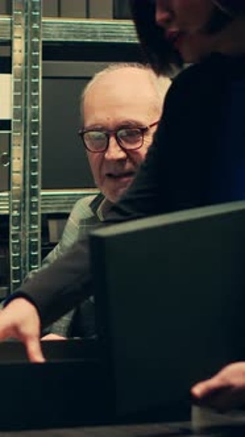 Man and Woman Reviewing Documents from Black Box