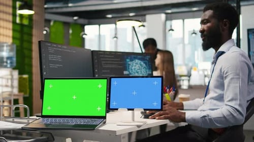 Software Developer Using AI on Isolated Screen Laptop and Tablet