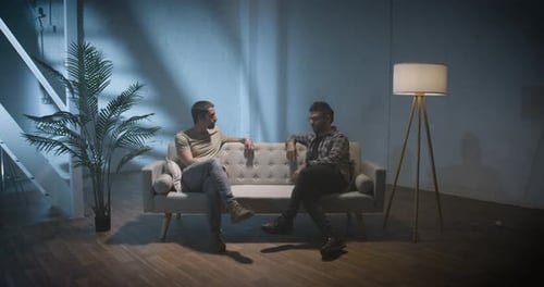 Two Men on a Couch Interview Scene Talking and Sharing Stories Podcast Concept
