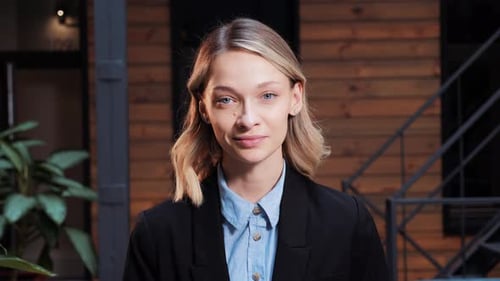 Confident Young Woman Smiling in Business Attire