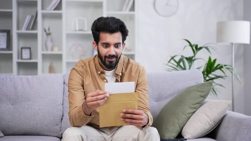 Man Celebrating Good News From Letter at Home
