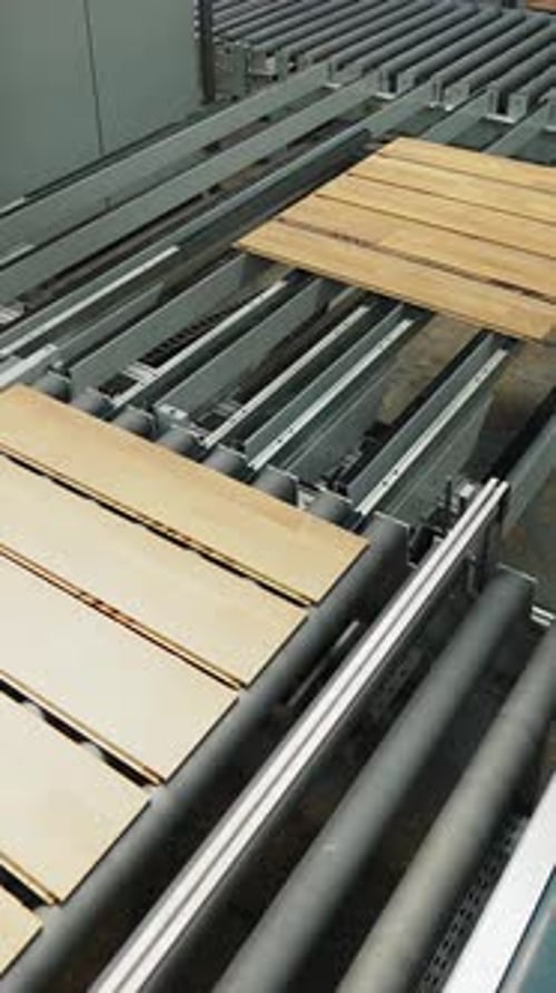 parquet board are processed on the production line in the woodworking plant.