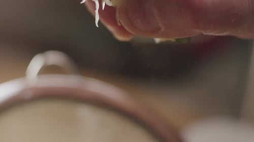 The hand of a person squeezing juice from a lime, cooking process close up