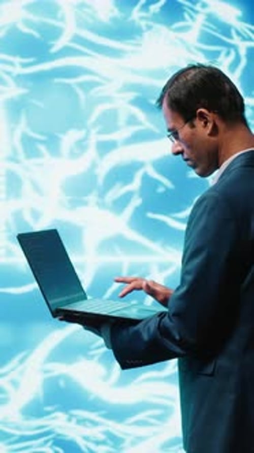 Man Typing on Laptop with Digital Background