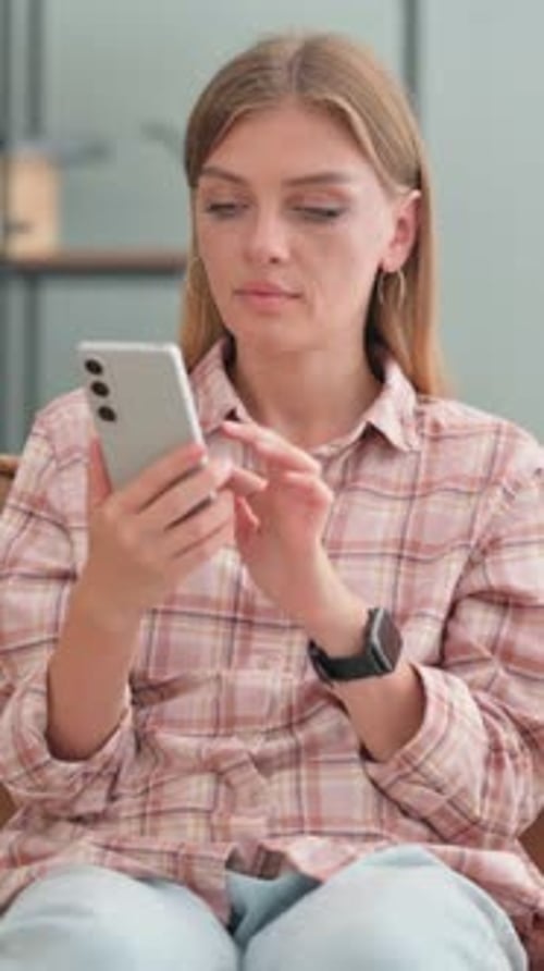 Woman Using Smartphone Indoors