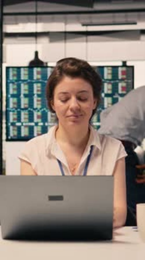 Vertical Video Female Professional Reviewing Monetary Data and Taxes for Compliance