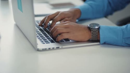 Closeup of a Man's Hand Uses a Laptop Clock on Hand Prints on the Keyboard Office Online Table