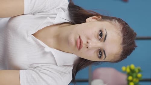 Young Woman Posing Indoors Looking at Camera