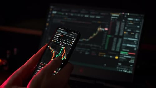 Crypto Businessman Working with Stock Market Data Graph on a Smartphone