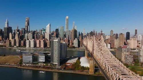 Camera Panning Across the East River Highlights the Roosevelt Island and Queensboro Bridge Framed By