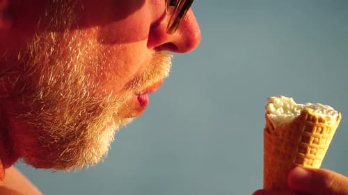 Man Enjoys Refreshing Ice Cream Treat Outdoors