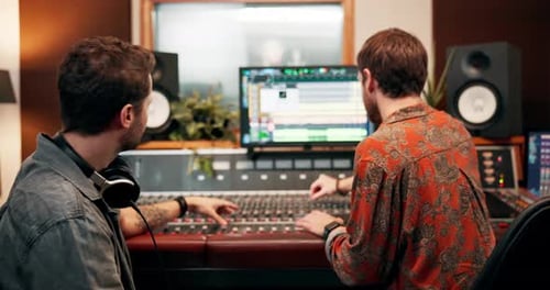 Men, partners and music producer in recording studio for sound or audio mixing with equipment