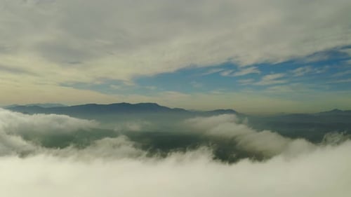 4k drone footage of clouds high above a mountainous area