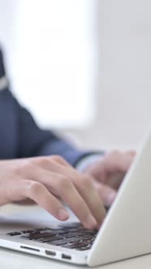 Businessman Typing on Laptop, vertical video