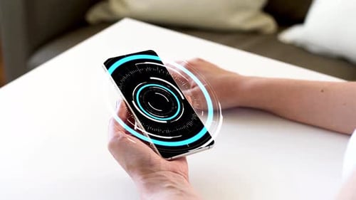 Hand holding phone with technology graphic overlay