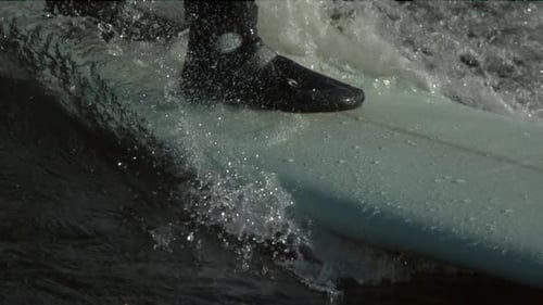 Surfer Riding Surfboard in Ocean Water Close Up