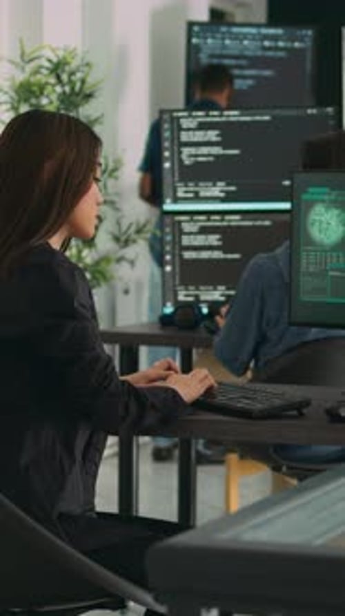 Woman Typing at Computer With 'Critical Error' Message