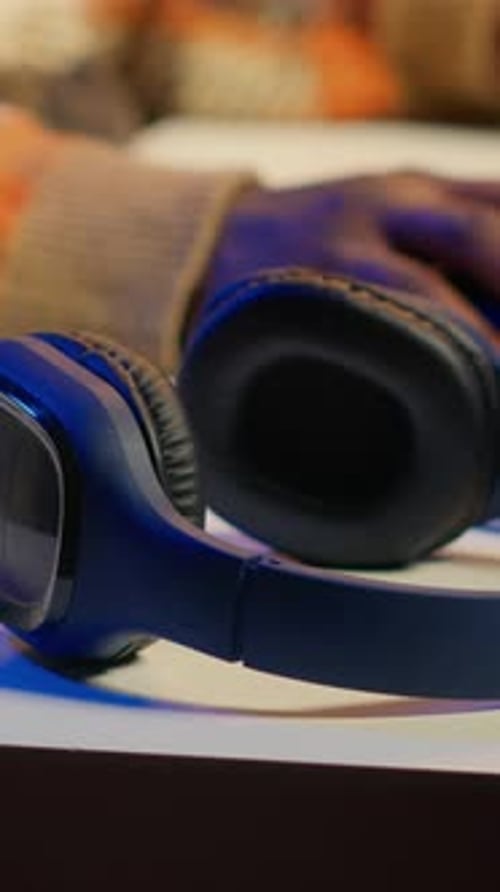 Young Adult Puts On Wireless Headphones At Night