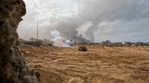 Israeli IDF army tanks bombard buildings and housing in the Gaza strip