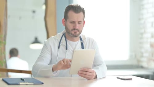 Doctor using Tablet in Clinic