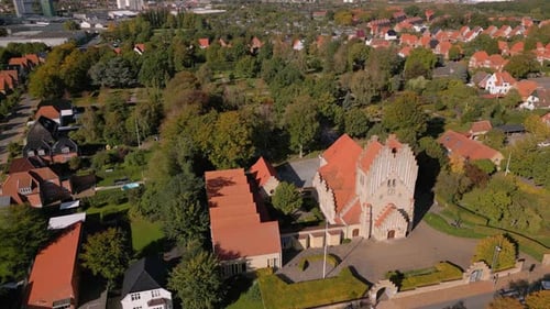 Aerial shot of church in urban area on a sunny day