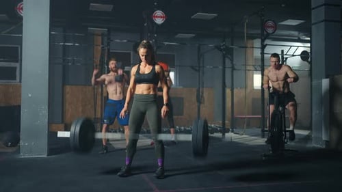 Strong Woman is Lifting Barbell in Gym Professional Powerlifter Training in Fitness Deadlift
