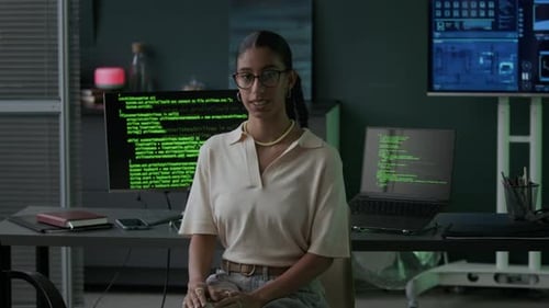 Portrait of Female Programmer in Office with Running Program Codes on Screens