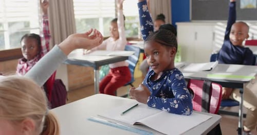 In school, students raising hands and participating in classroom discussion