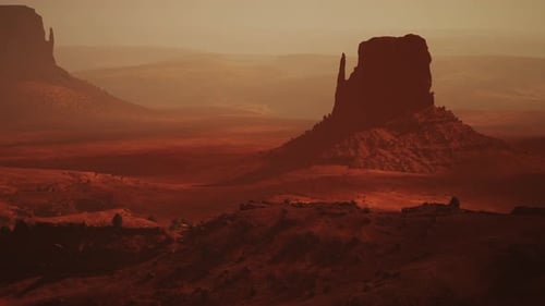 Un paysage désertique époustouflant avec une majestueuse formation rocheuse au loin
