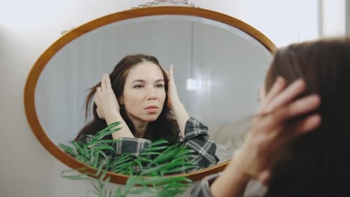 Woman Looking in Mirror Indoors