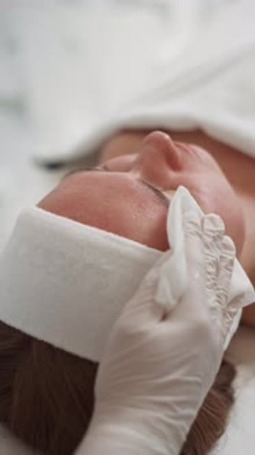 Woman Receiving Facial Treatment at Spa