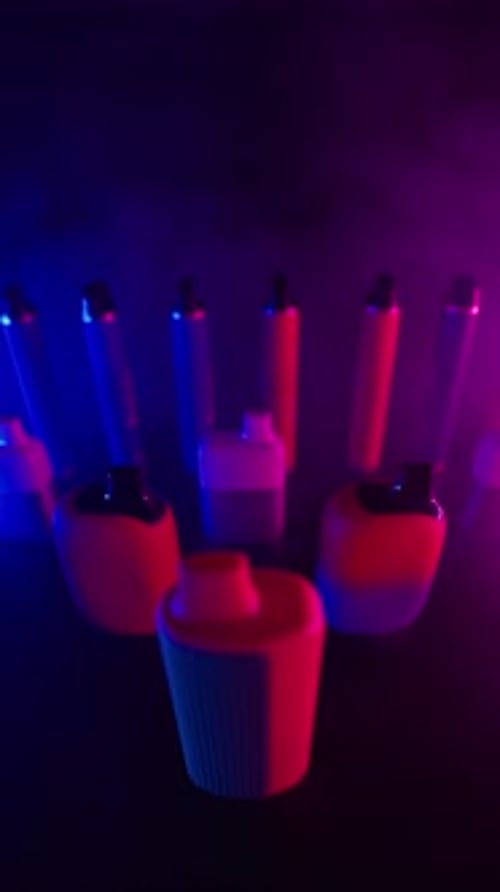 Colorful Disposable Vape Pens in a Dark Environment